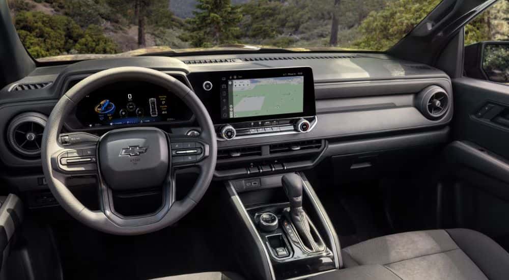 2026 Chevy Colorado front interior with steering wheel and infotainment.