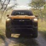 Yellow 2026 Chevy Colorado on a dirt road from the front.