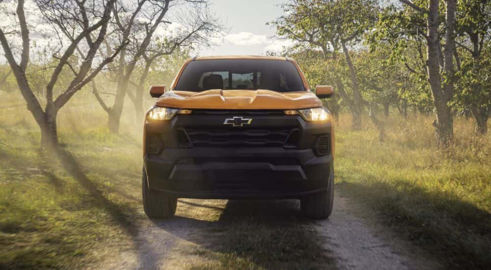 Yellow 2026 Chevy Colorado on a dirt road from the front.