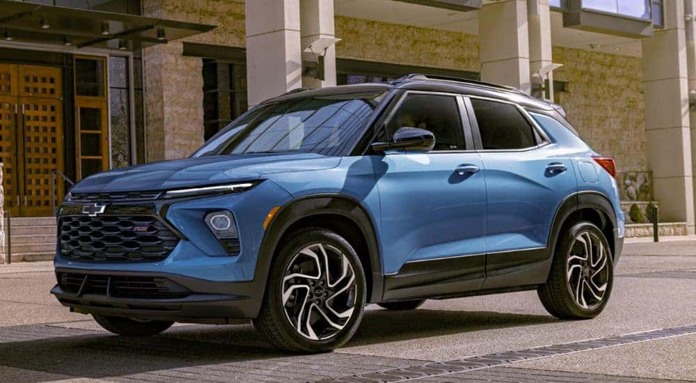 A blue 2026 Chevy Trailblazer RS parked next to a building.