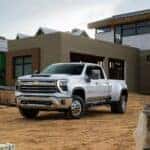 A white 2026 Chevy Silverado 2500 HD shown parked at a home construction site.