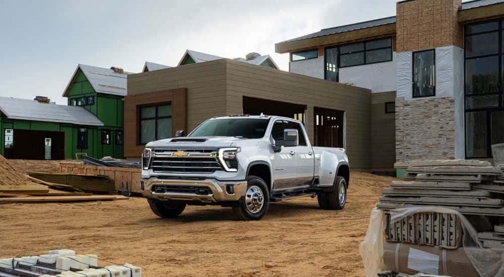 A white 2026 Chevy Silverado 2500 HD shown parked at a home construction site.