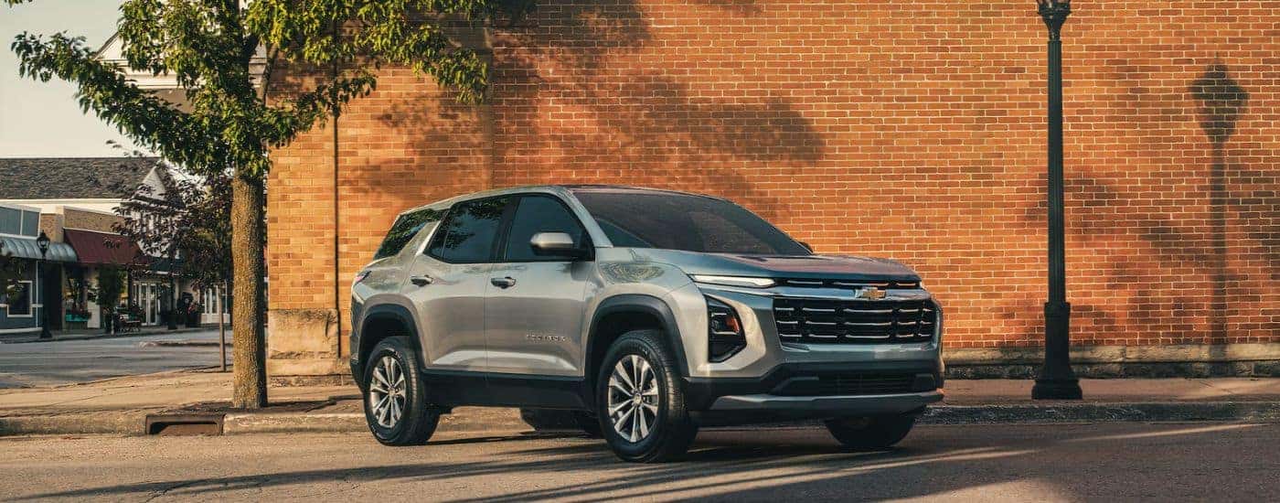 Grey 2026 Chevy Equinox parked near a brick building.