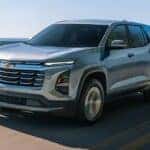 Grey 2026 Chevy Equinox driving along the coast.
