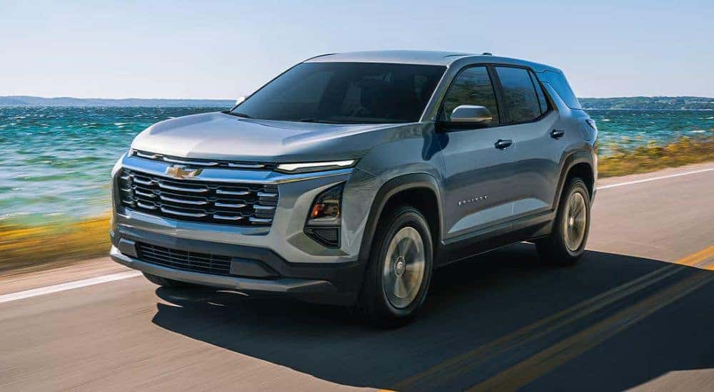 Grey 2026 Chevy Equinox driving along the coast.