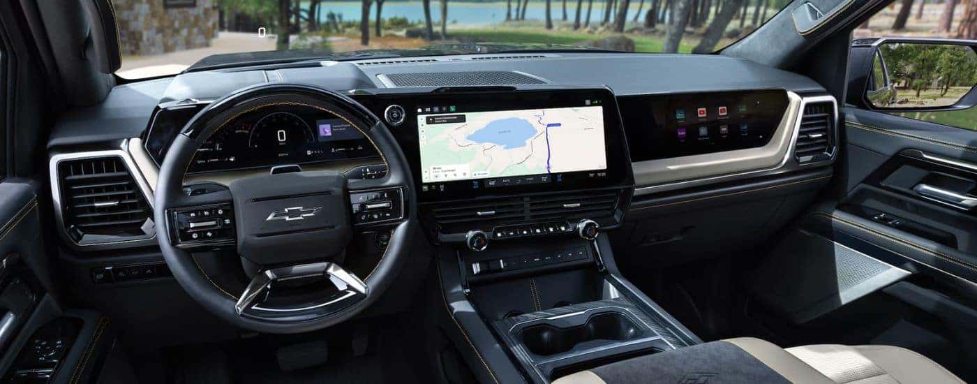 A 2027 Silverado 1500 black interior infotainment and steering.