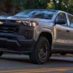 A silver 2026 Chevy Colorado driving on a highway.