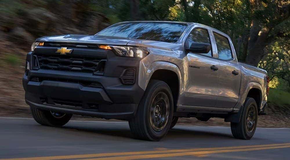A silver 2026 Chevy Colorado driving on a highway.