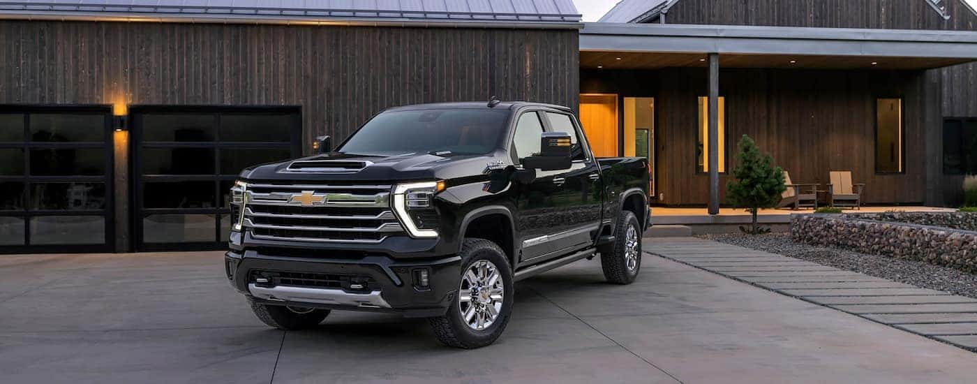 Black 2026 Chevy Silverado 2500 HD parked on a driveway.