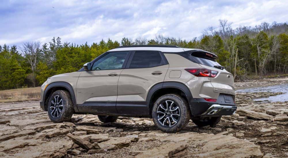 A White Sands 2027 Chevy Trailblazer ACTIV AWD driver side parked on rocks.