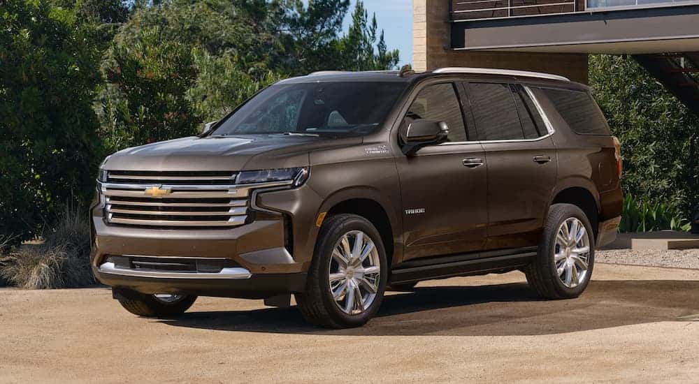 A brown 2021 Chevy Tahoe angled left in a driveway.