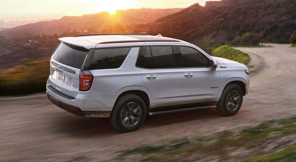 A white 2021 Chevy Tahoe driving off-road.