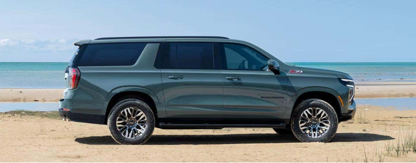 Green 2026 Chevy Suburban Z71 parked on a beach.