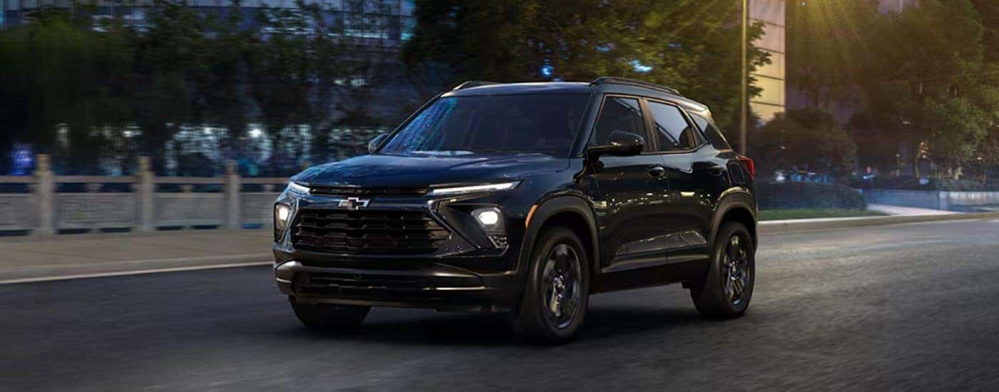 A black 2027 Chevy Trailblazer driving at night.