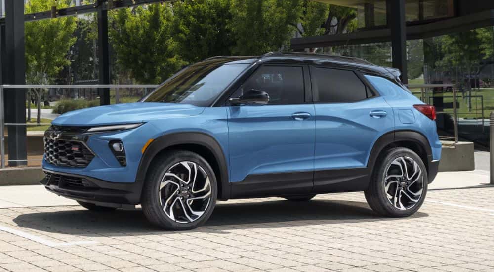 A blue 2027 Chevy Trailblazer RS parked on cobblestone.