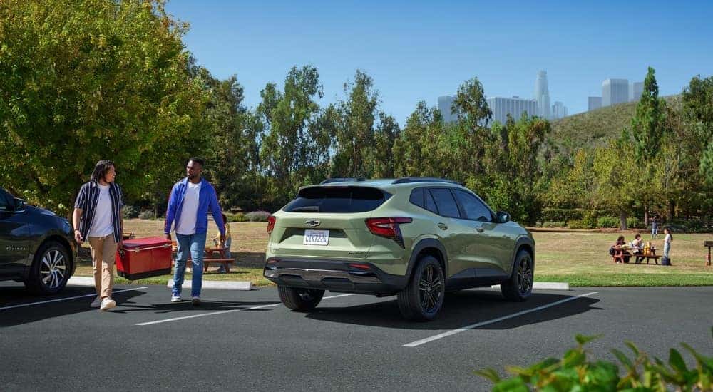 A green 2026 Chevy Trax ACTIV parked by a field.