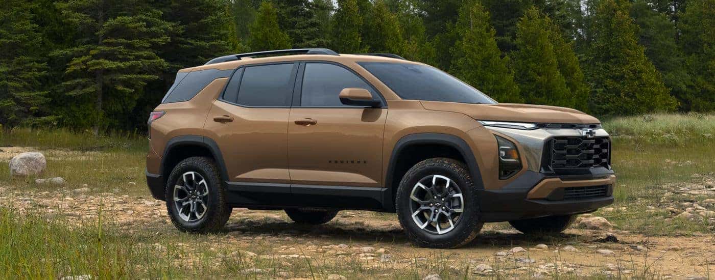 A light brown 2027 Chevy Equinox angled right off-road.