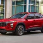 A red 2026 Chevy Trax 2RS driving in a city.