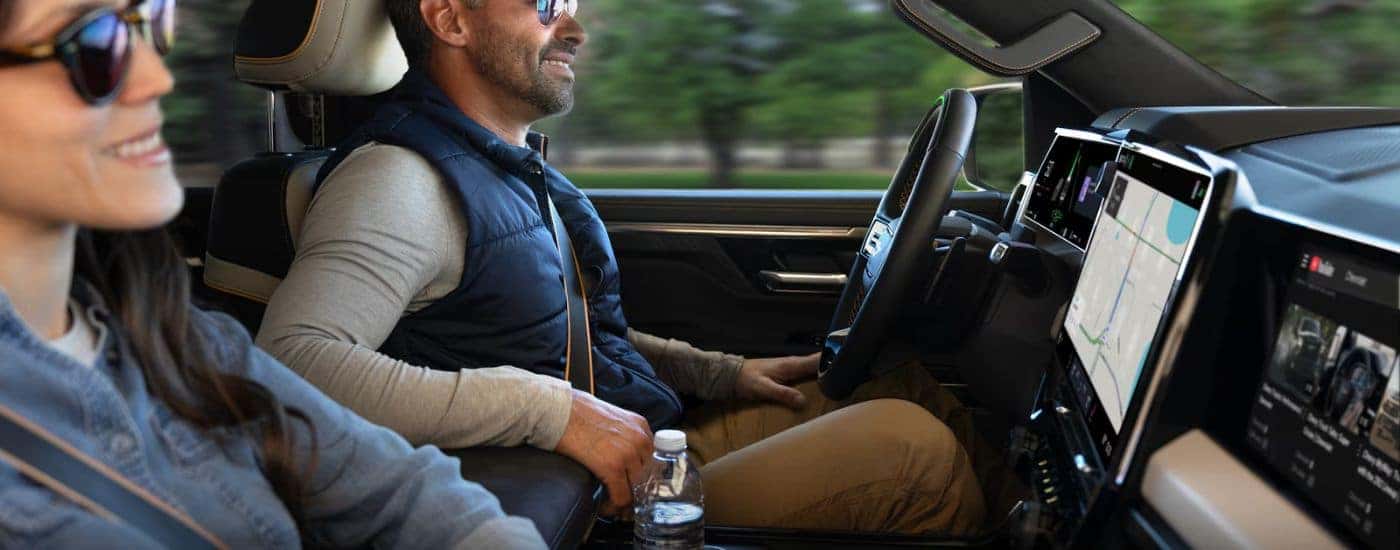 Interior view of a 2027 Silverado 1500 with a couple driving.