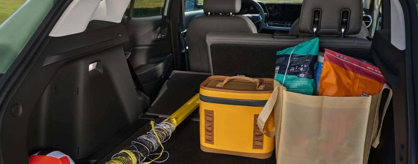 Rear cargo area with beach supplies in a 2026 Chevy Trax.