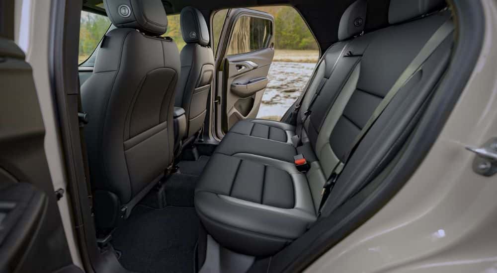 Rear seat view of black leather seats in a tan 2027 Chevy Trailblazer.