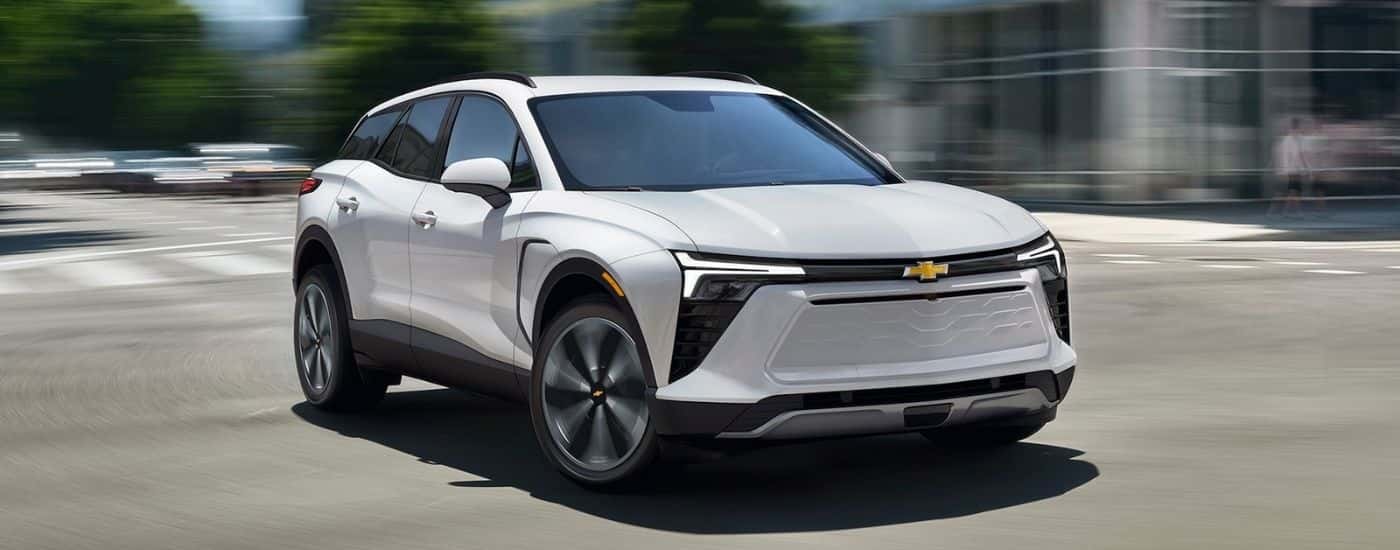 White 2027 Chevy Blazer EV LT driving through an intersection
