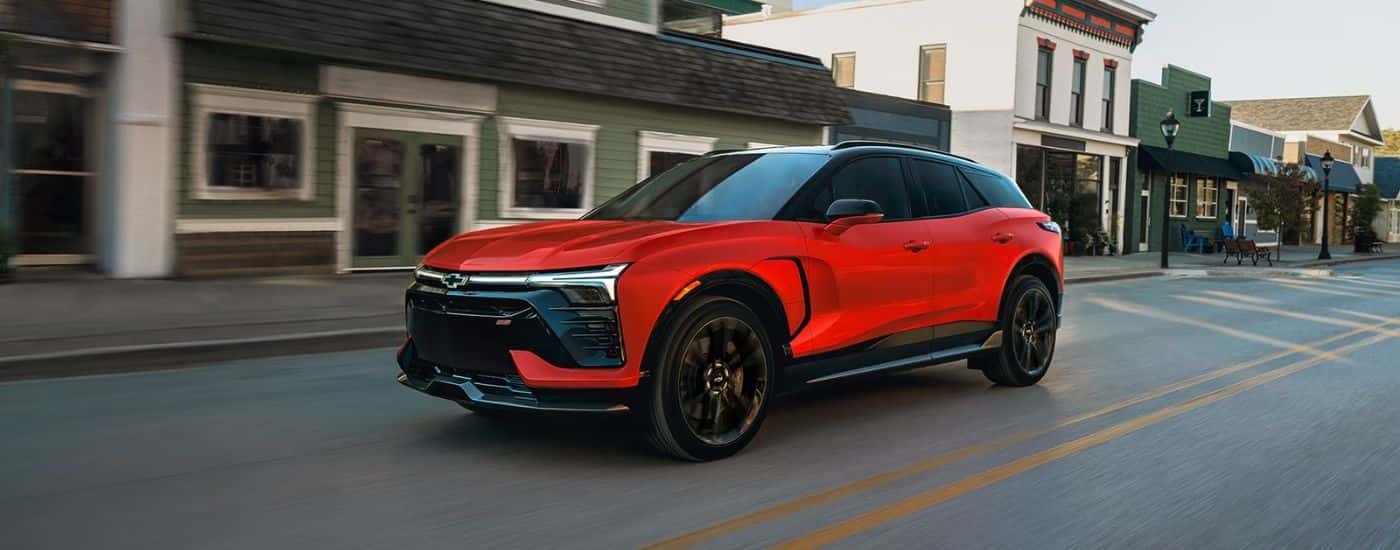 Red 2027 Chevy Blazer EV SS driving through a town center