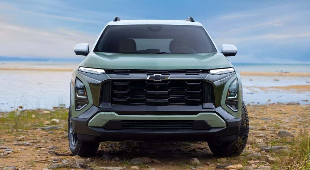 A green 2025 Chevy Equinox ACTIV parked near a lake
