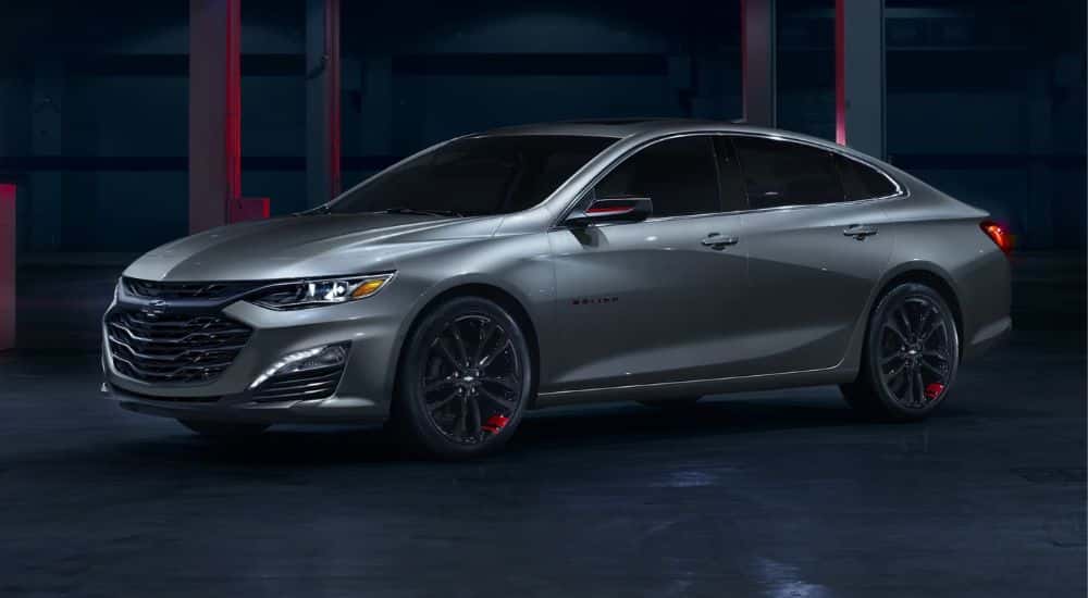 A silver 2024 Chevy Malibu Redline parked in a warehouse