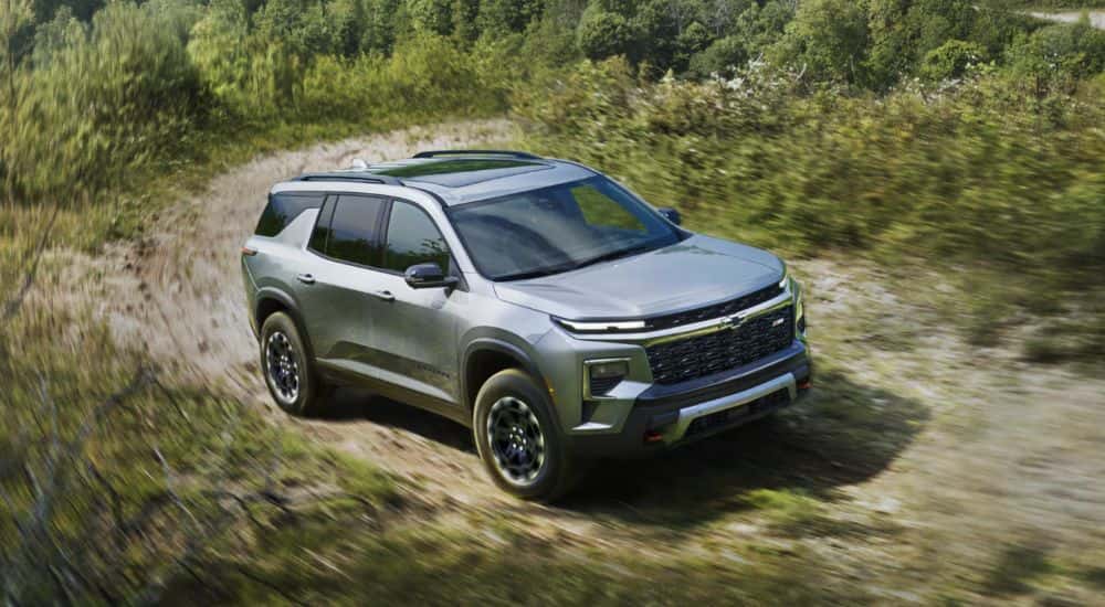 A silver 2027 Chevy Traverse Z71 driving off-road.