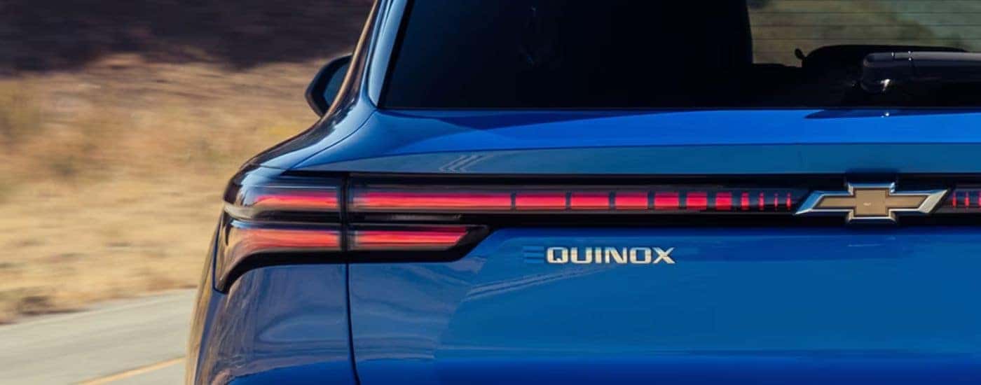 Badging on the rear gate of a blue 2027 Chevy Equinox EV.