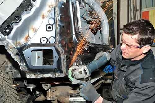Body Shop Mechanic working on a car
