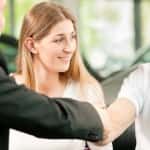 Man shakes dealers hand after buying a car