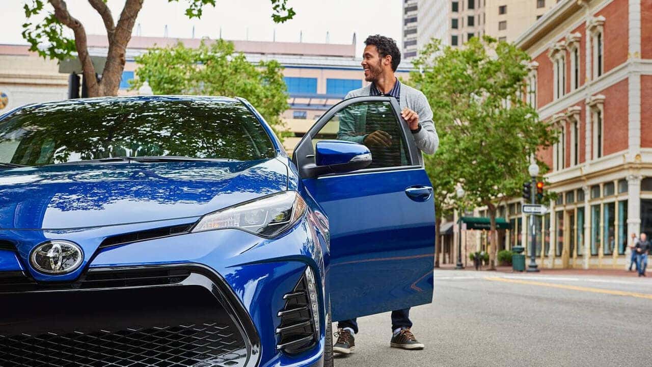 Entering a blue 2018 Toyota Corolla