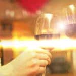 couple toasting with wine and surrounding heart graphics