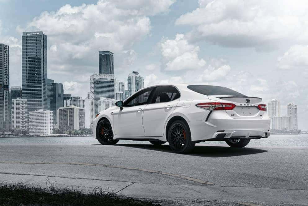Toyota Camry XP rear view in front of city