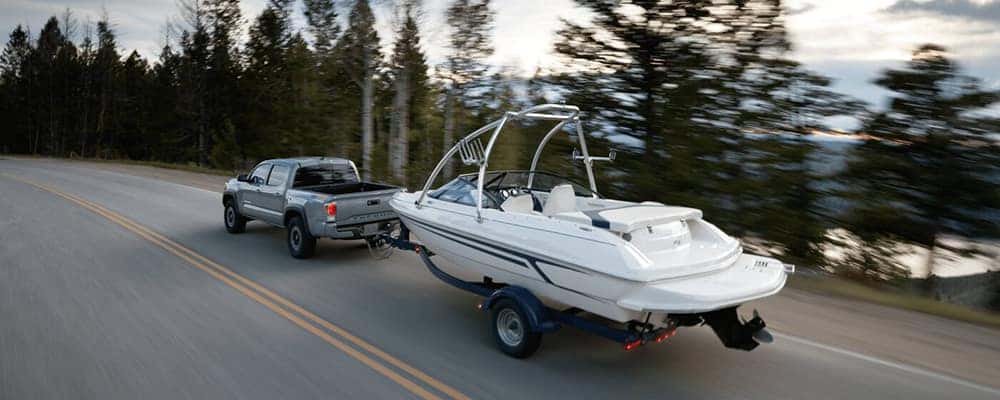 2020 toyota tacoma towing a boat on a highway