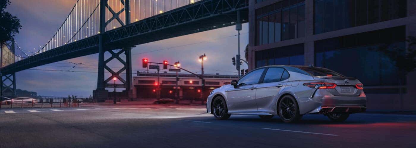 2021 Toyota Camry Hybrid parked near bridge