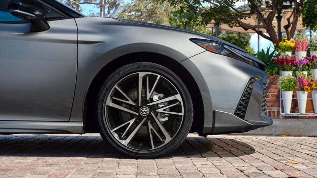 Close up of 2025 Toyota Camry Hybrid wheel and front design highlighting aerodynamic style and performance
