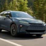 2025 Toyota Crown Signia driving on a scenic road