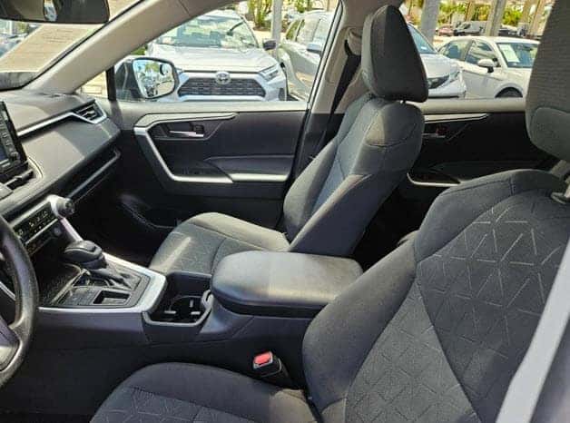 Front seats and center console of a pre-owned Toyota RAV4 available at Earl Stewart Toyota in Lake Park, FL