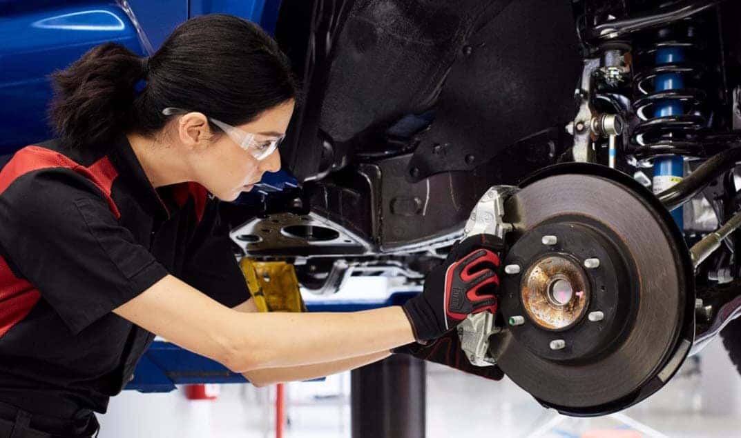 checking brakes during a post holiday car inspection