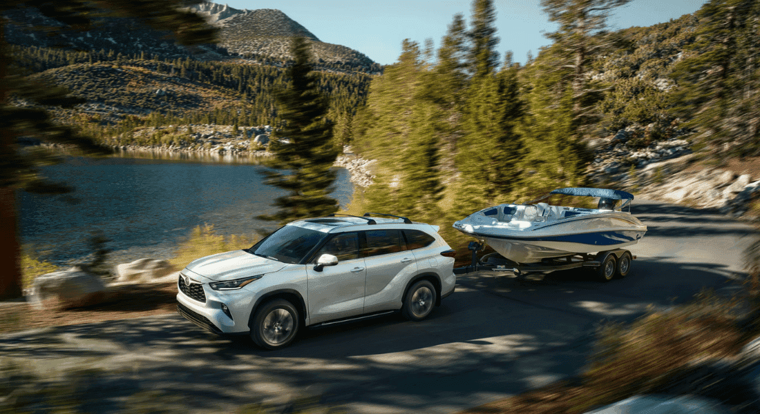 2026 Toyota Highlander towing a boat trailer