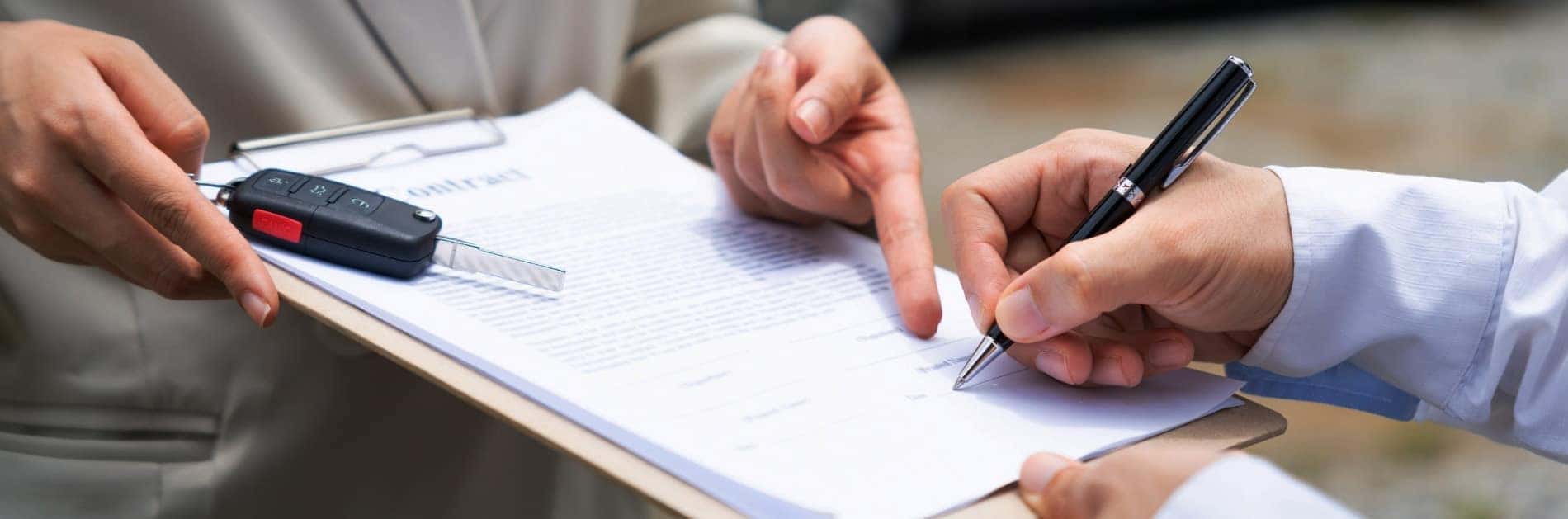 Signing a document verifying the trade in value of my car and handing over the keys