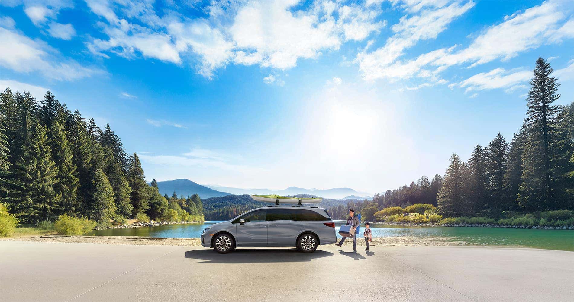 2025 Honda Odyssey parked at a mountain lake with an adult and a child unpacking gear from it