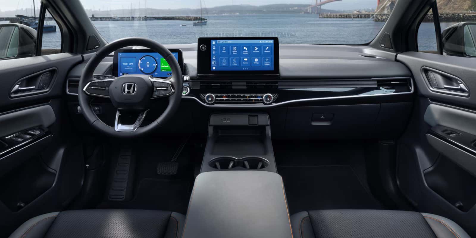 2026 Honda Prologue cabin view from the front seats overlooking a lake with a bridge accross it