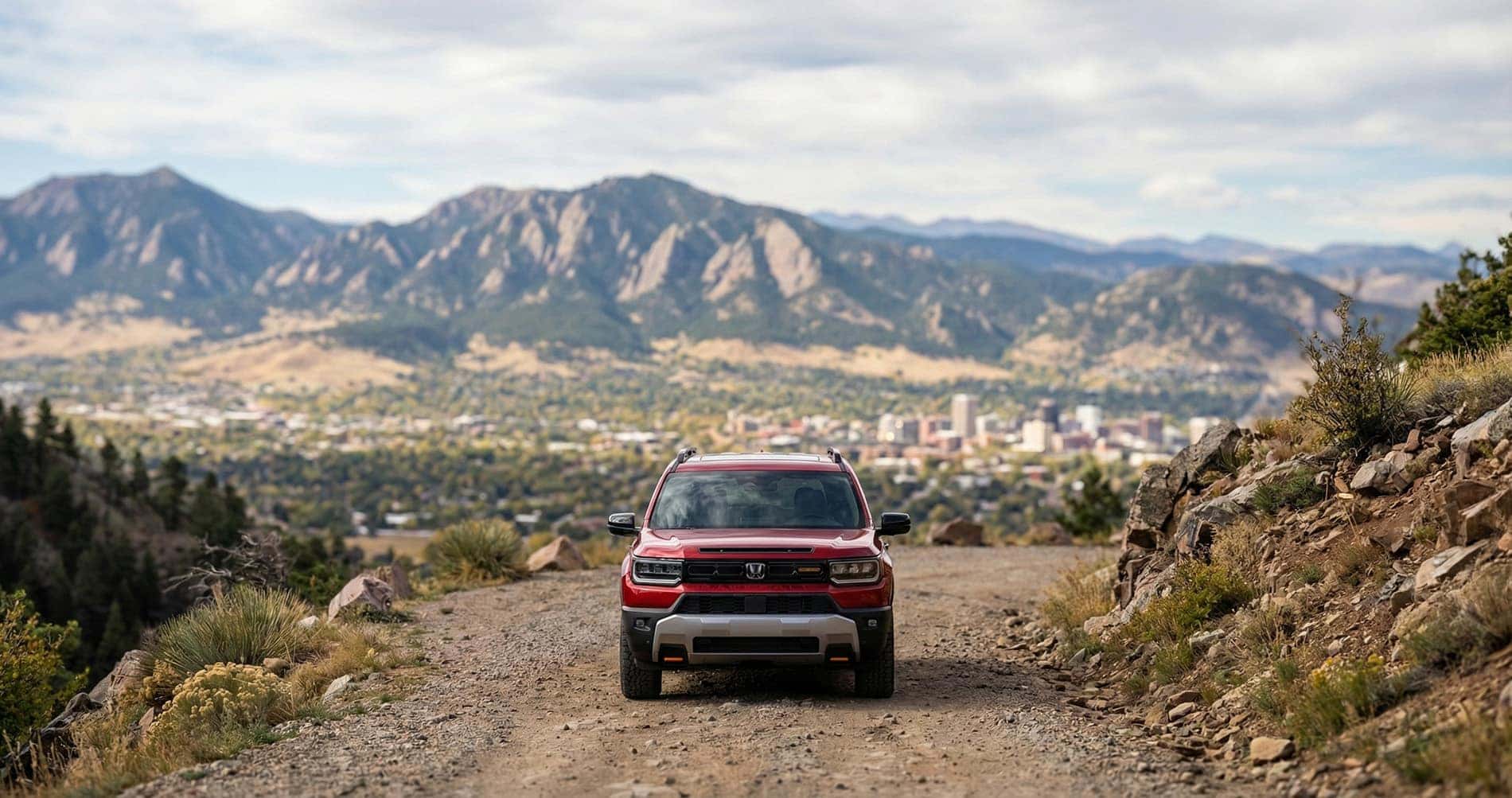 Honda Passport parked on a mountain overlooking a city in the valley below