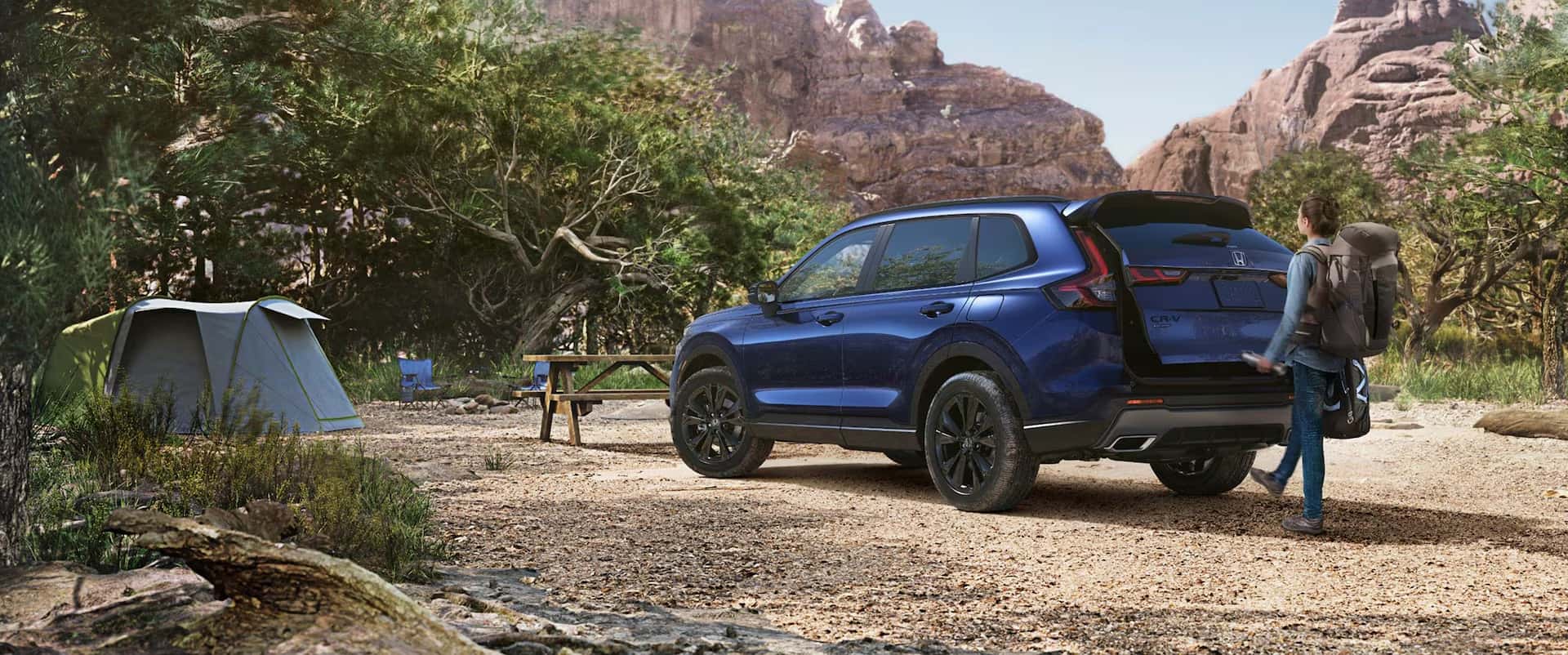 2026 Honda CR-V parked at a campsite with a tent and gear, highlighting cargo space and versatility for outdoor trips