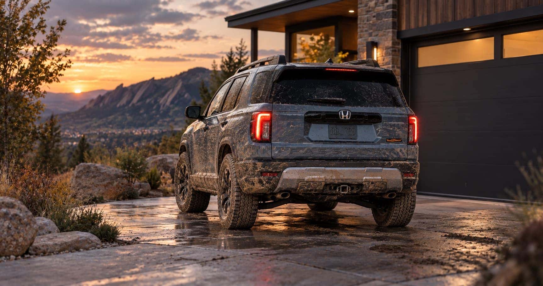 2027 Honda Passport TrailSport parked in a muddy residential driveway in Boulder, CO