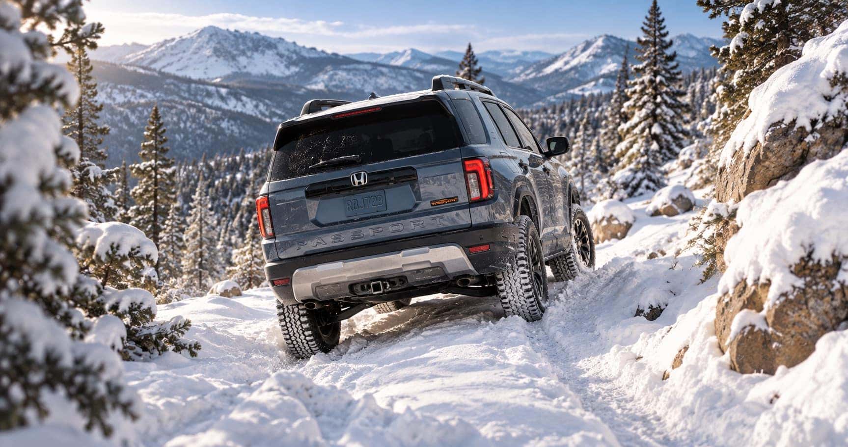 2027 Honda Passport TrailSport driving on a snowy mountain trail near Boulder, CO